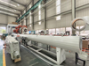 Jinglei Machinery vacuum calibration tank installed on a full pipe extrusion line for PVC pipe production